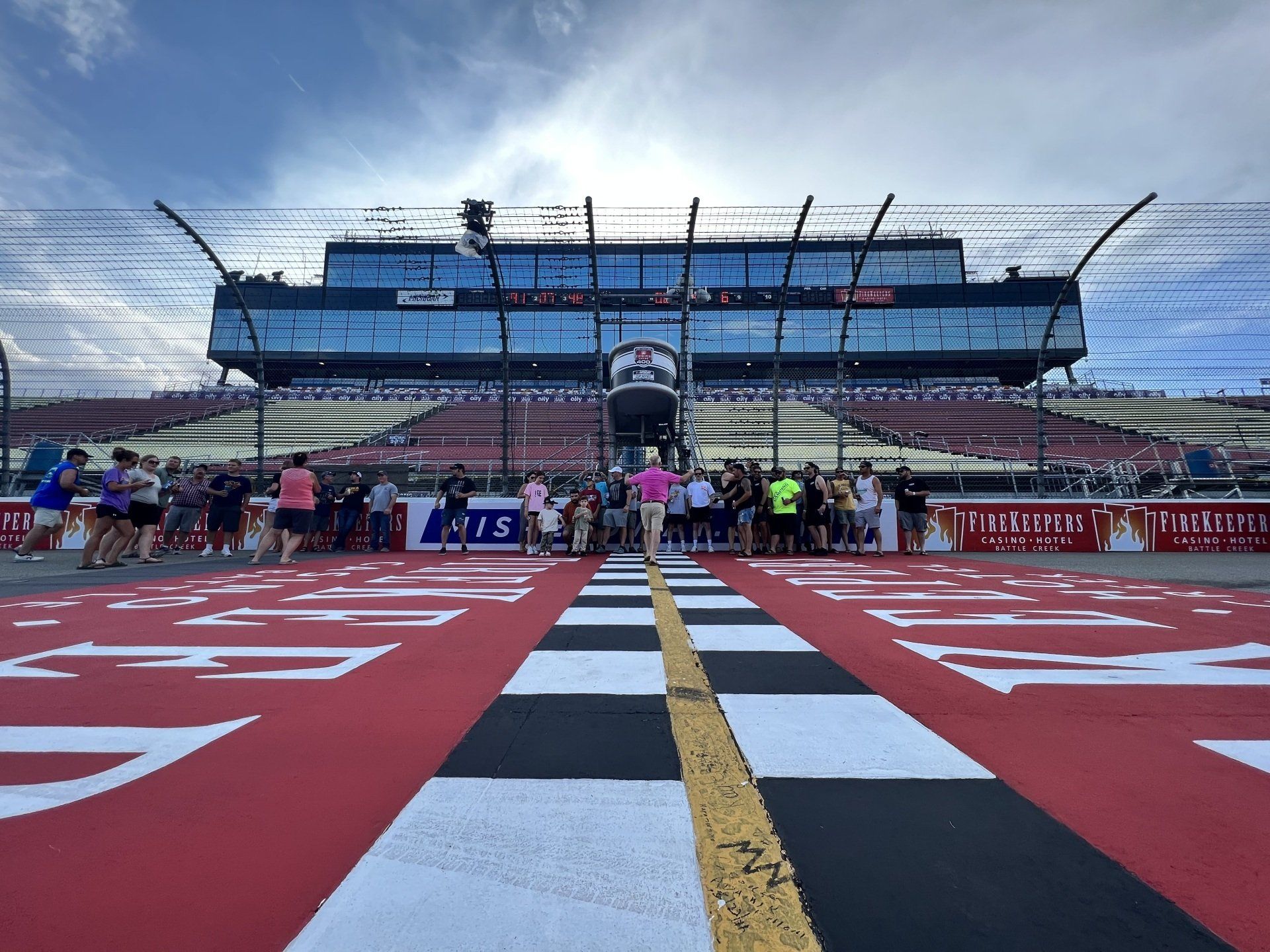 A group of people are standing in front of a race track