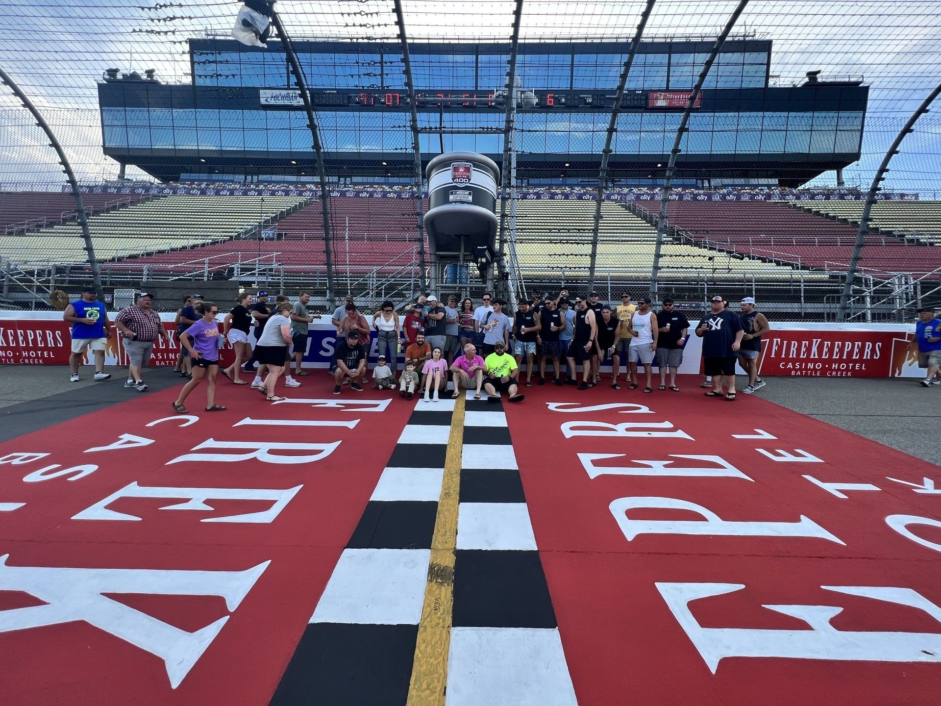 A group of people standing in front of a race track
