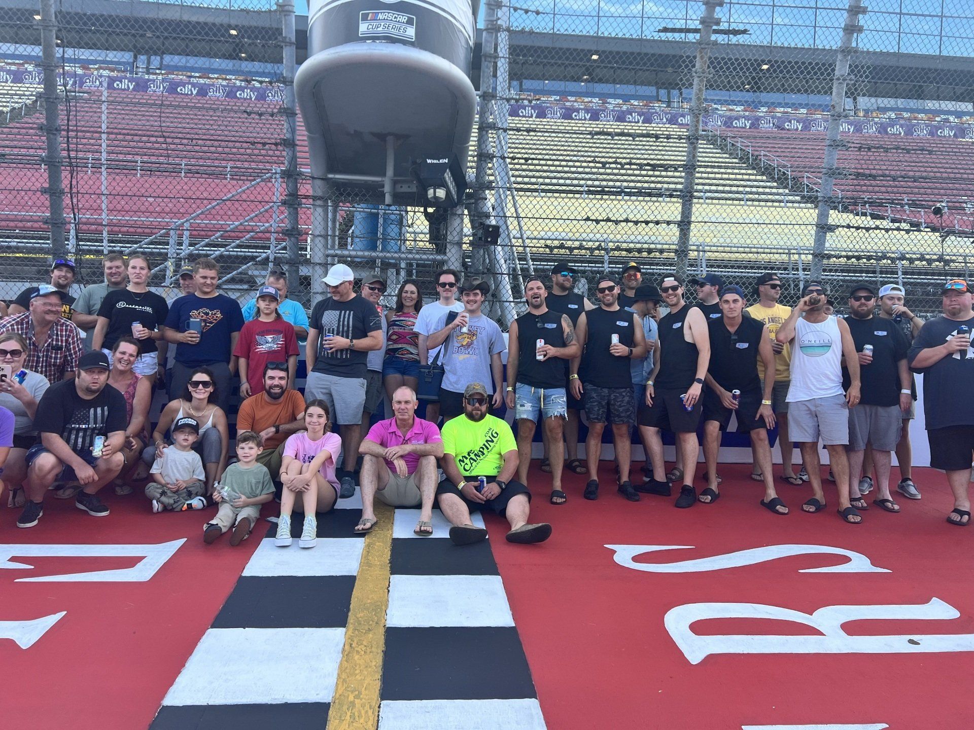 A group of people are posing for a picture in front of a sign that says rs