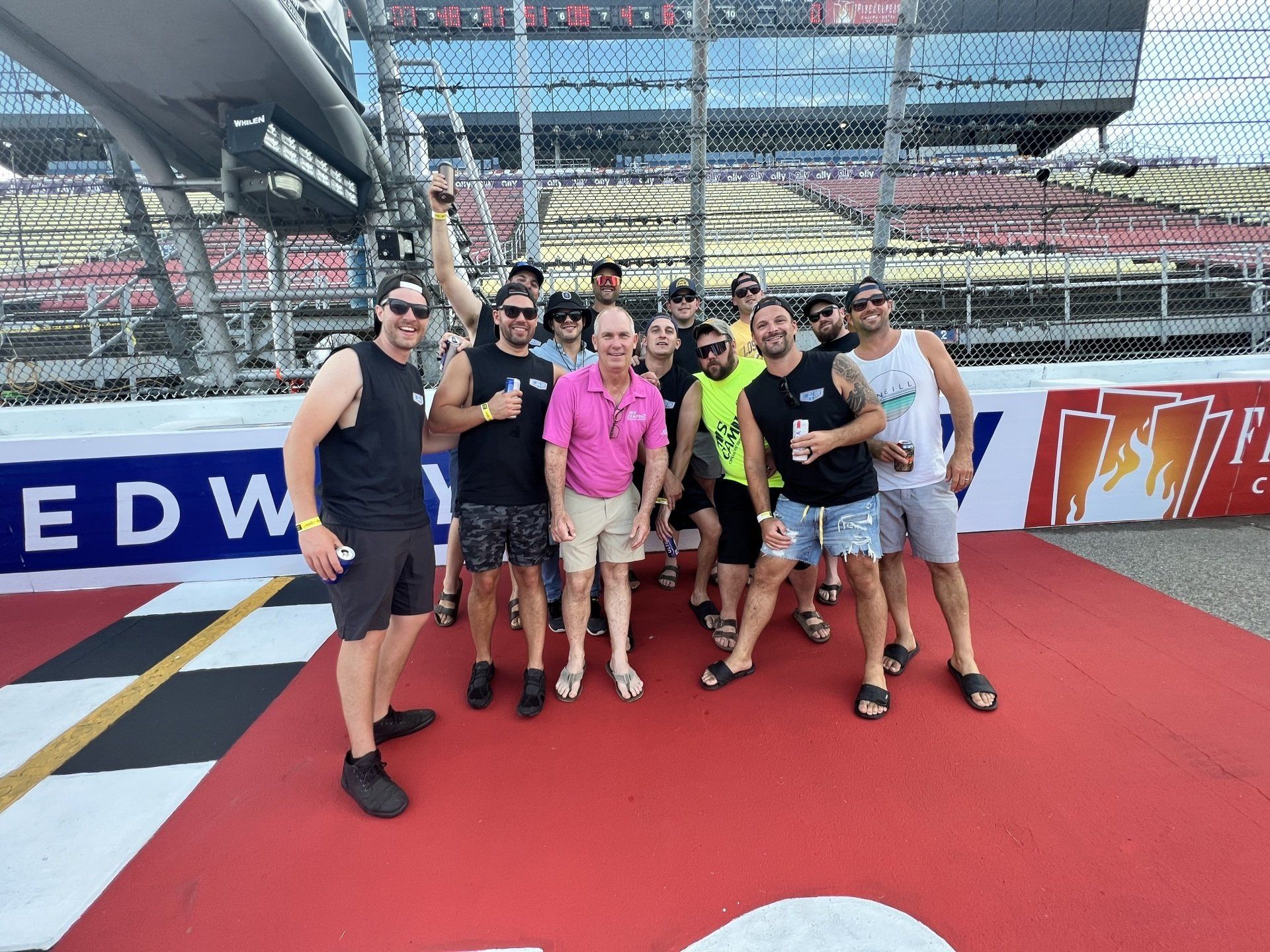 A group of men standing in front of a sign that says edw