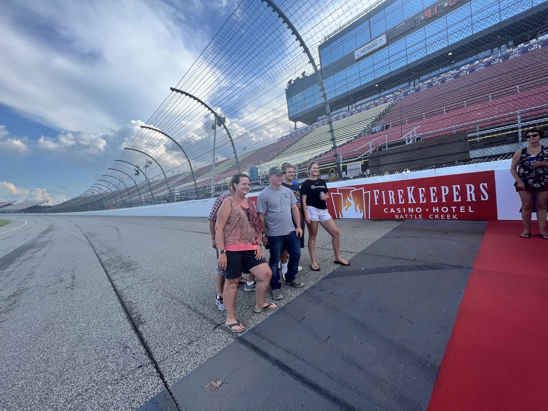A group of people are standing on a race track.