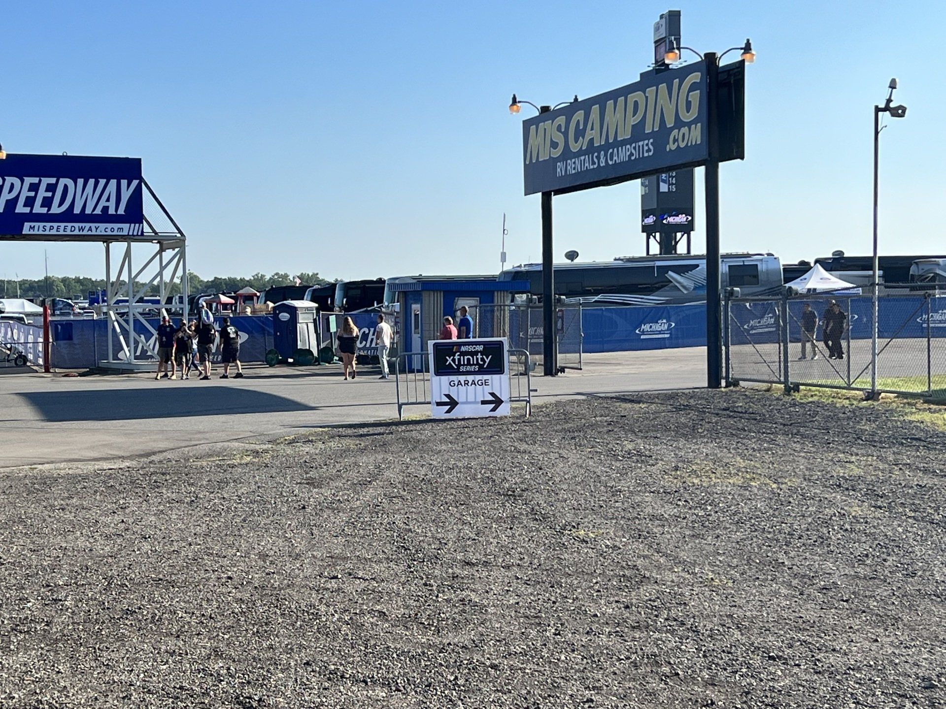 A sign that says speedway is above a dirt road.