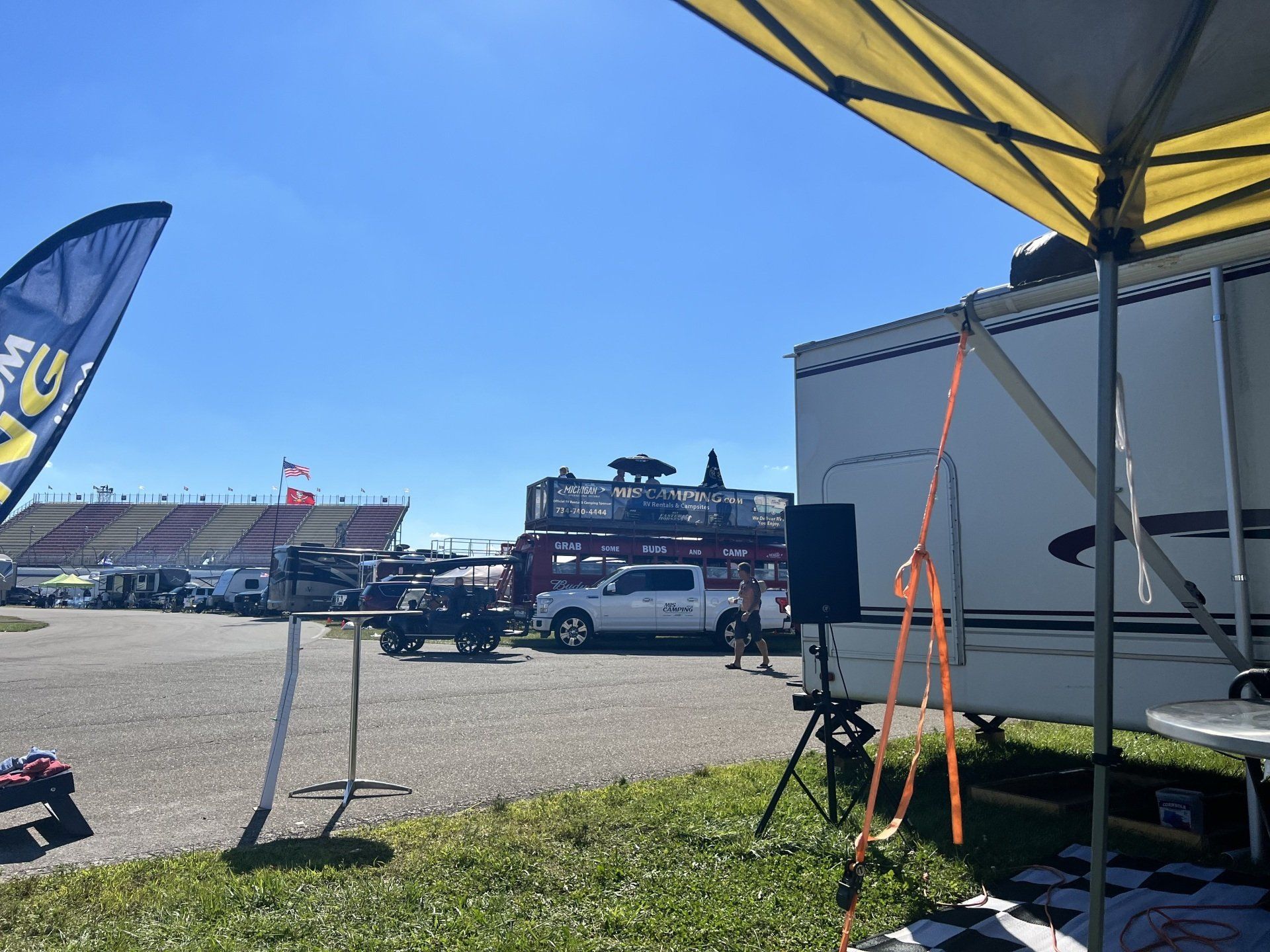 A rv is parked in front of a race track