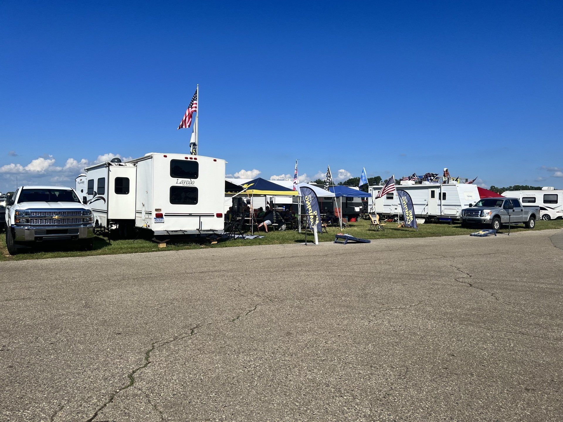 A group of rvs are parked on the side of the road.