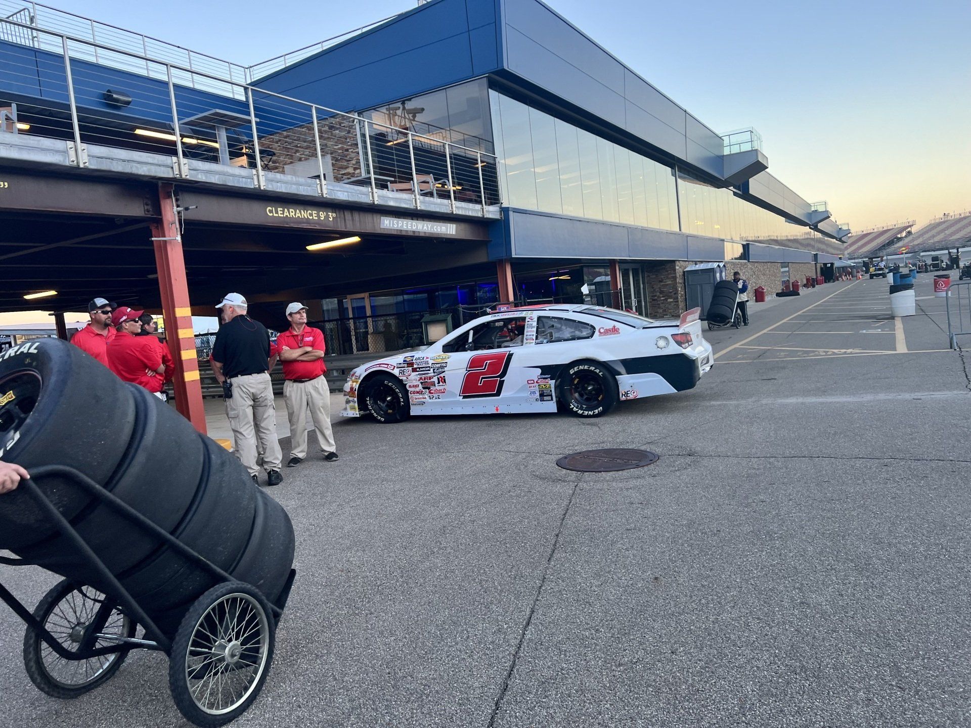 A race car is parked in front of a building