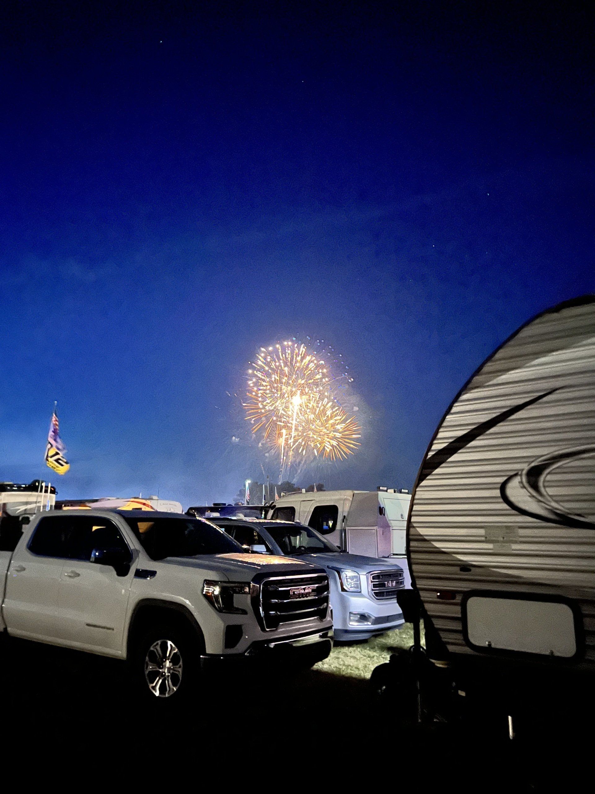 A rv is parked in front of a fireworks display.