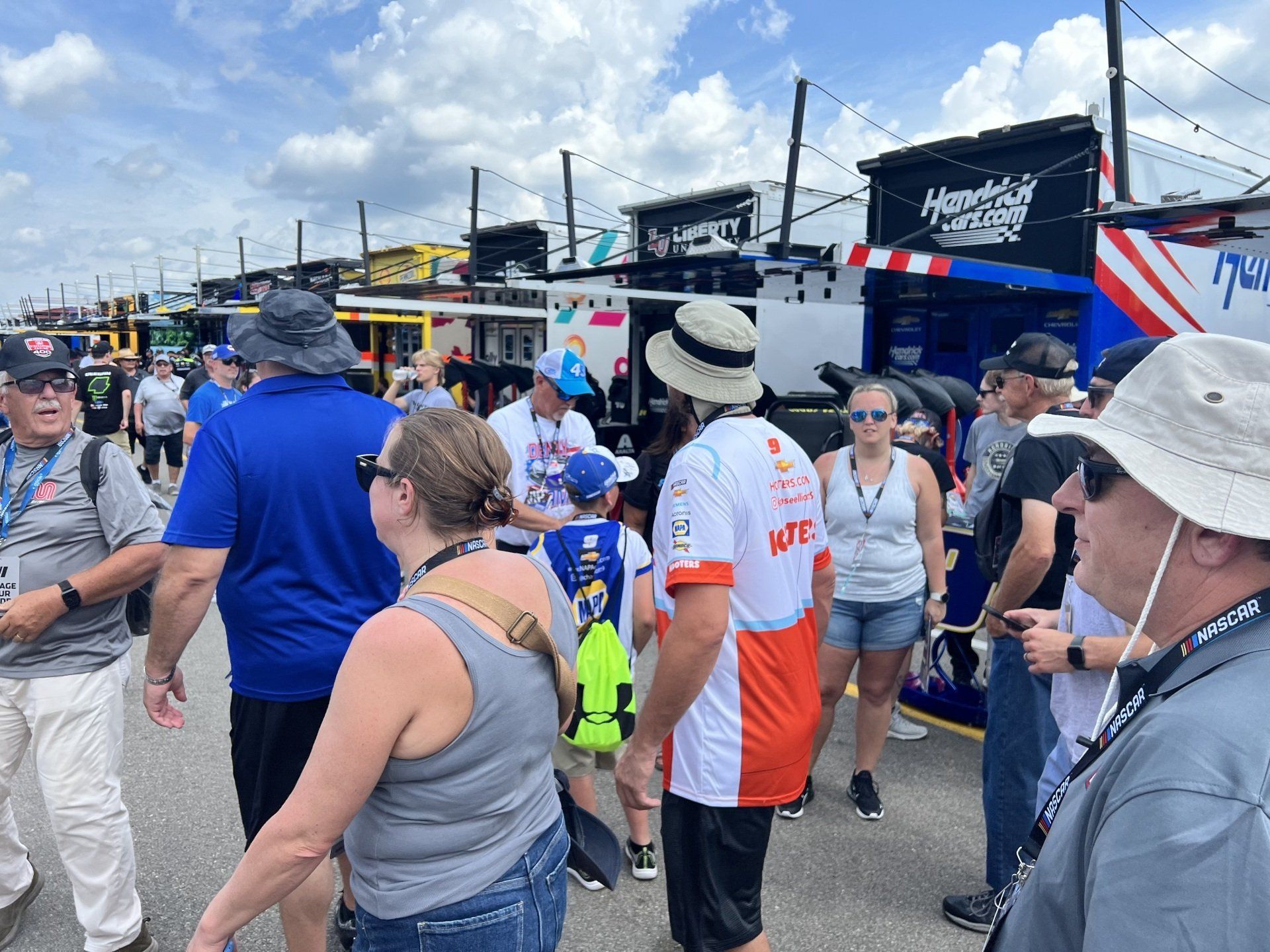 A group of people standing in front of a building that says mtc on it