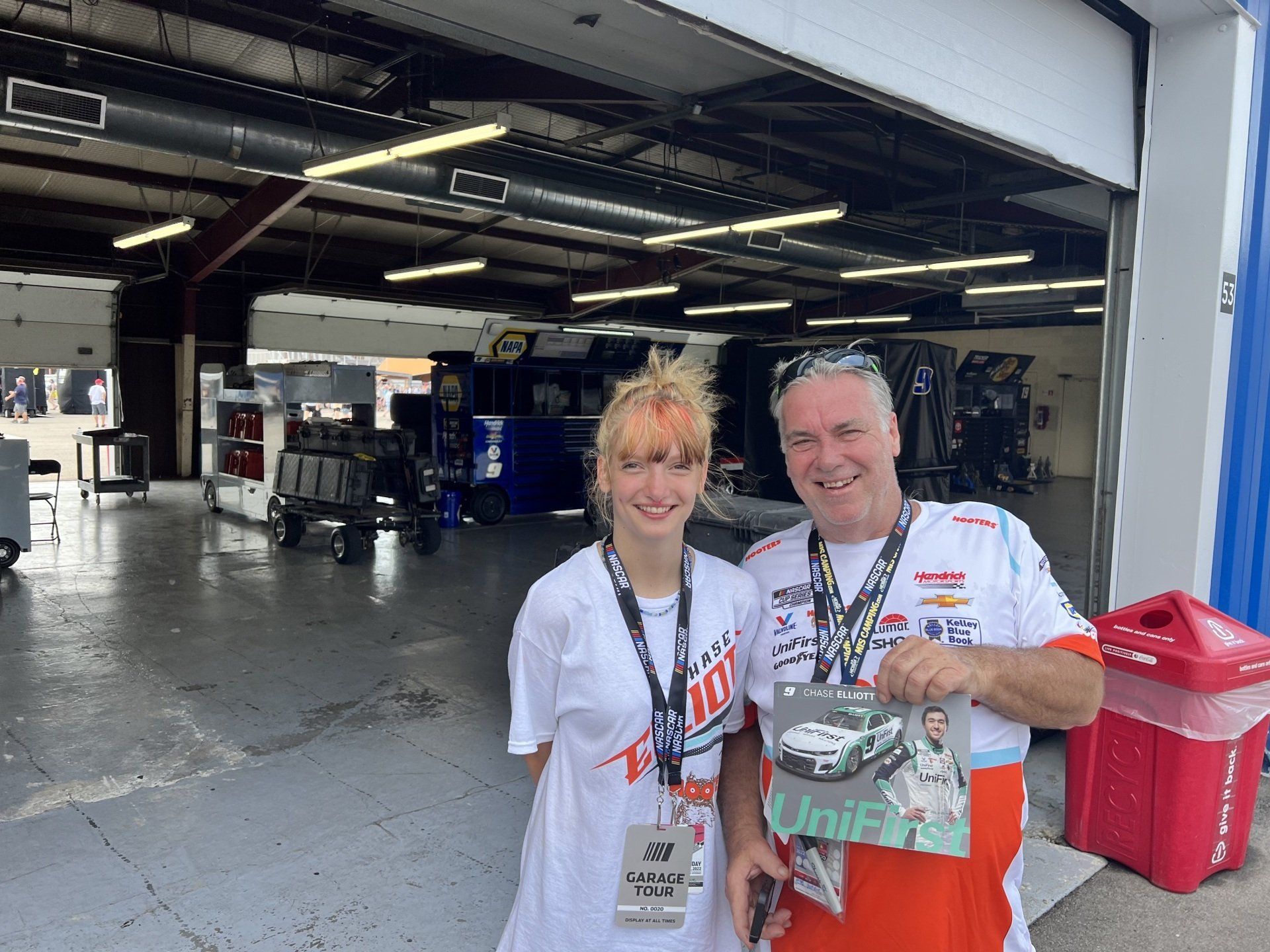A man and a woman are standing next to each other in a garage.