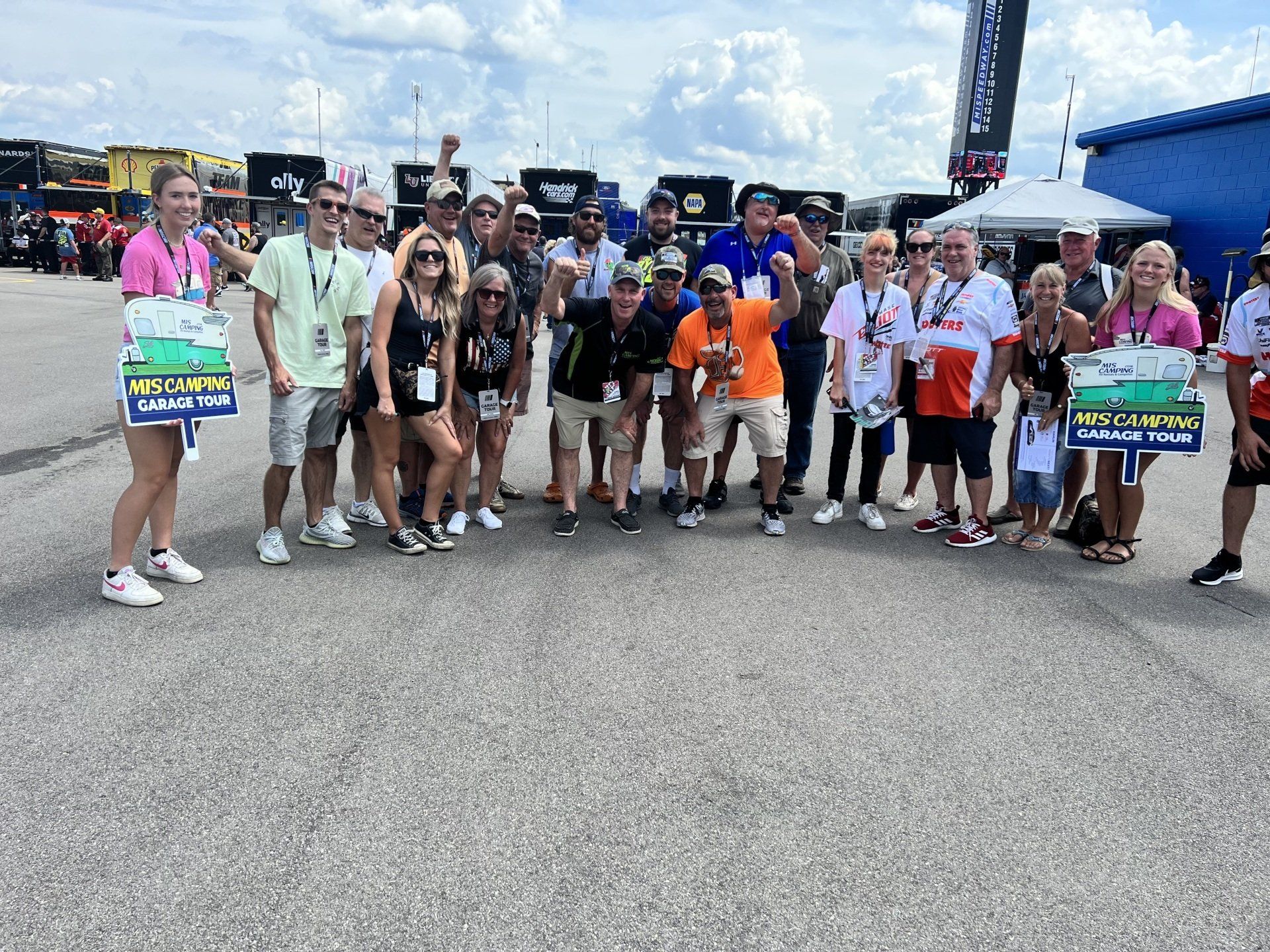 A group of people are posing for a picture while holding signs.