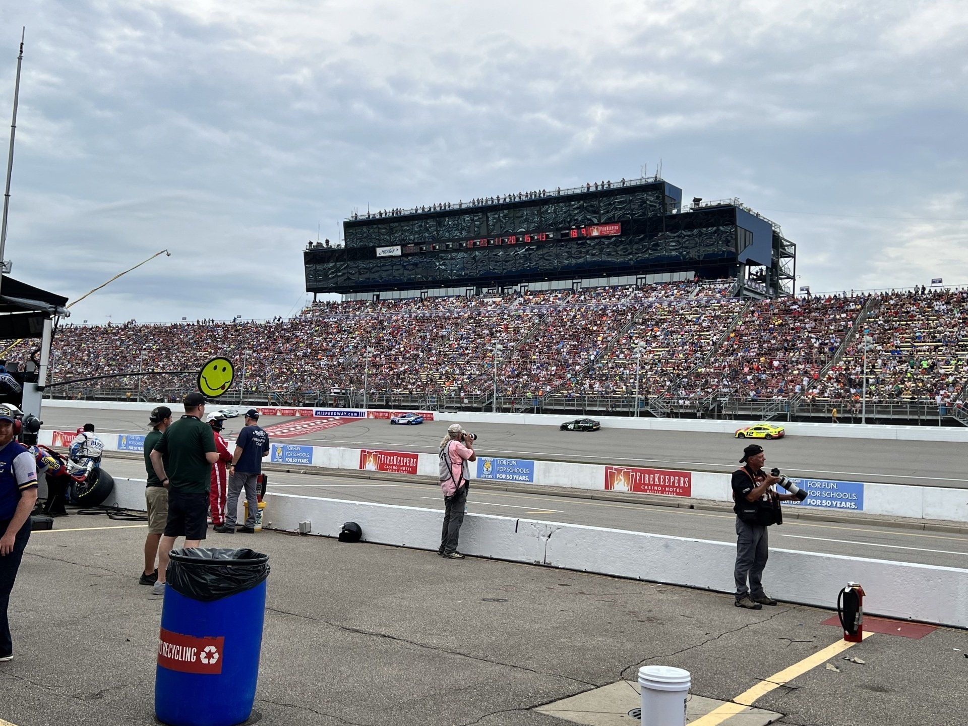 A race track with a large crowd watching a race