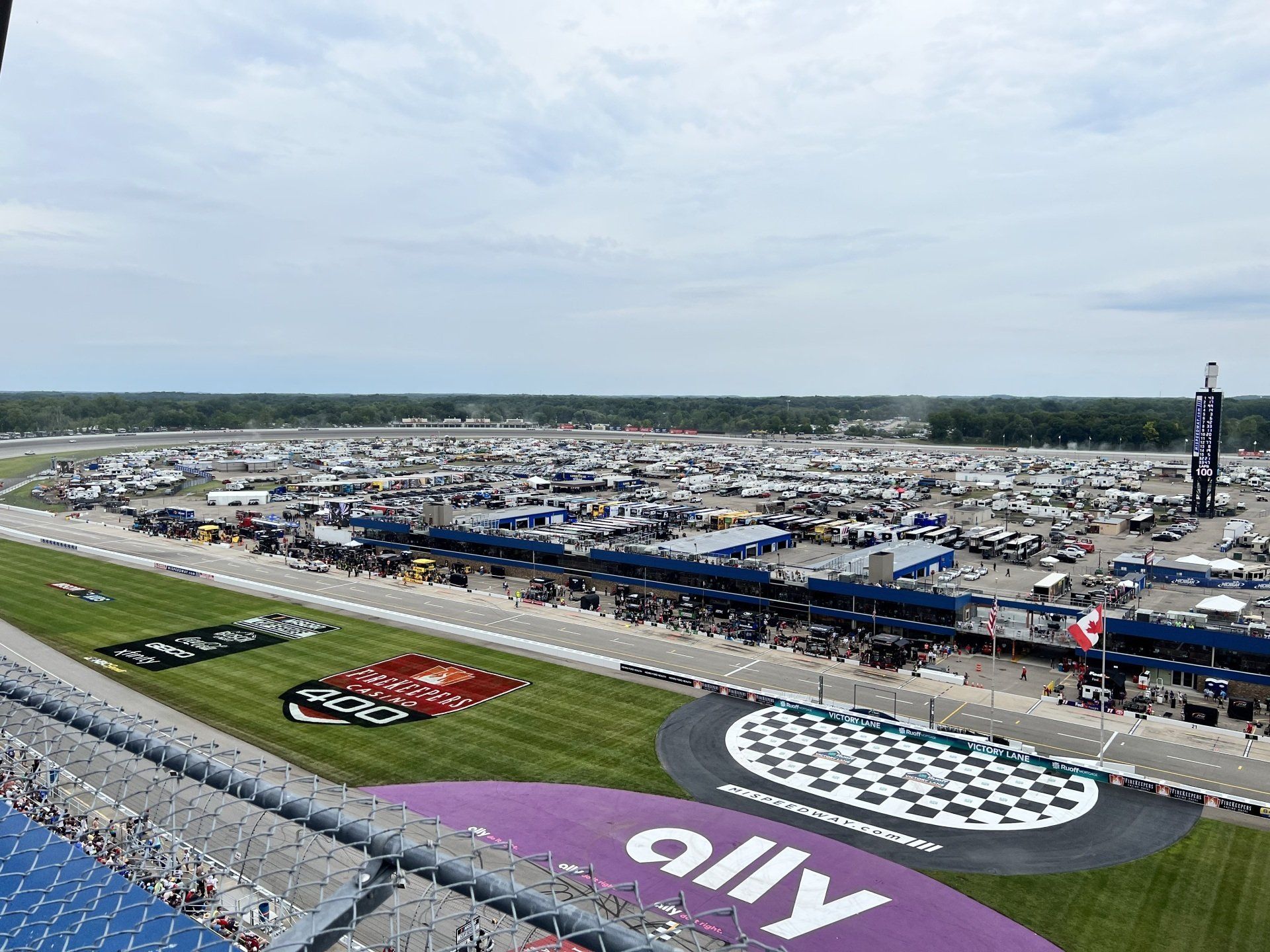 An aerial view of a race track with a purple sign that says ally