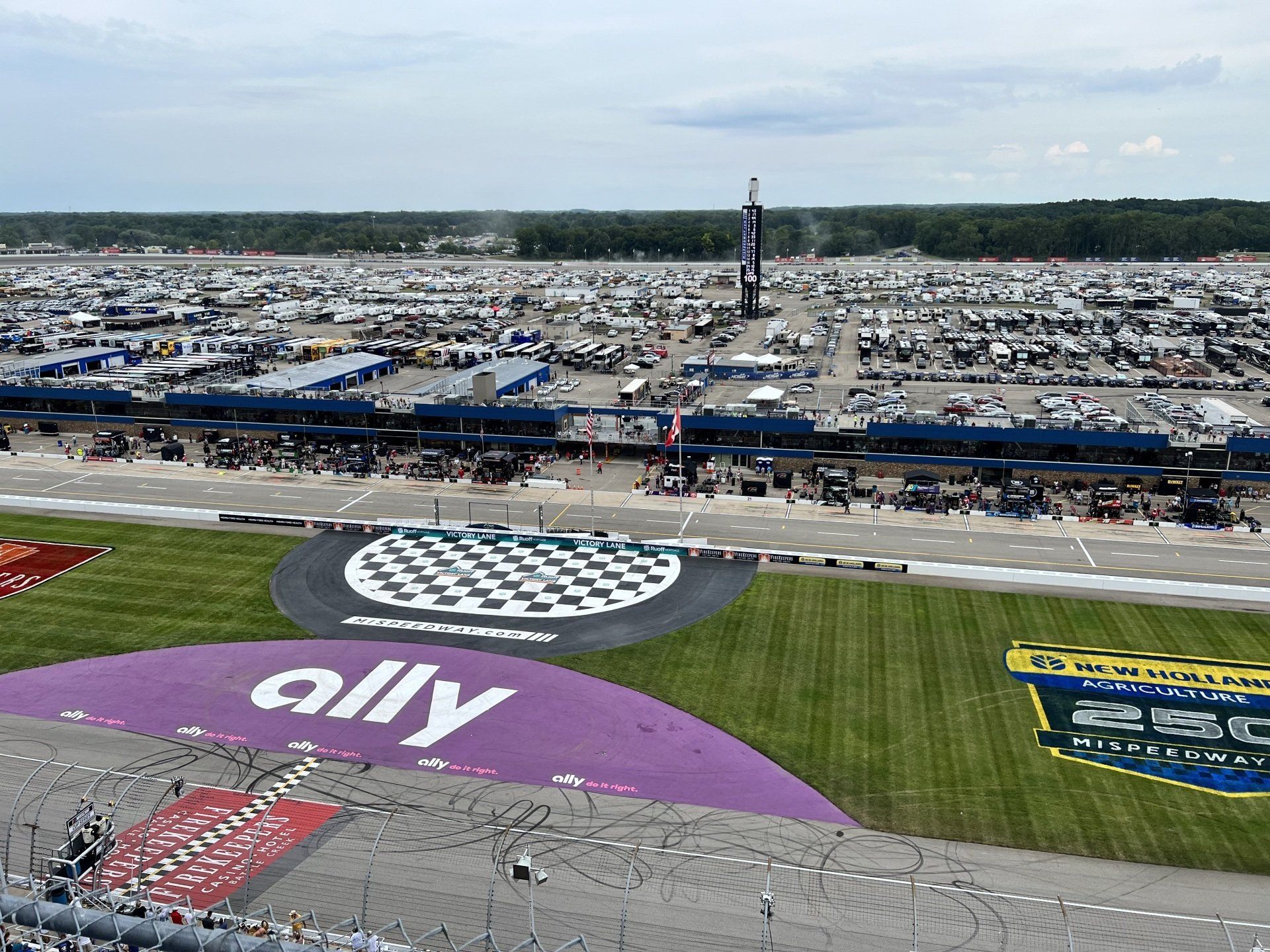 An aerial view of a race track with a large ally logo