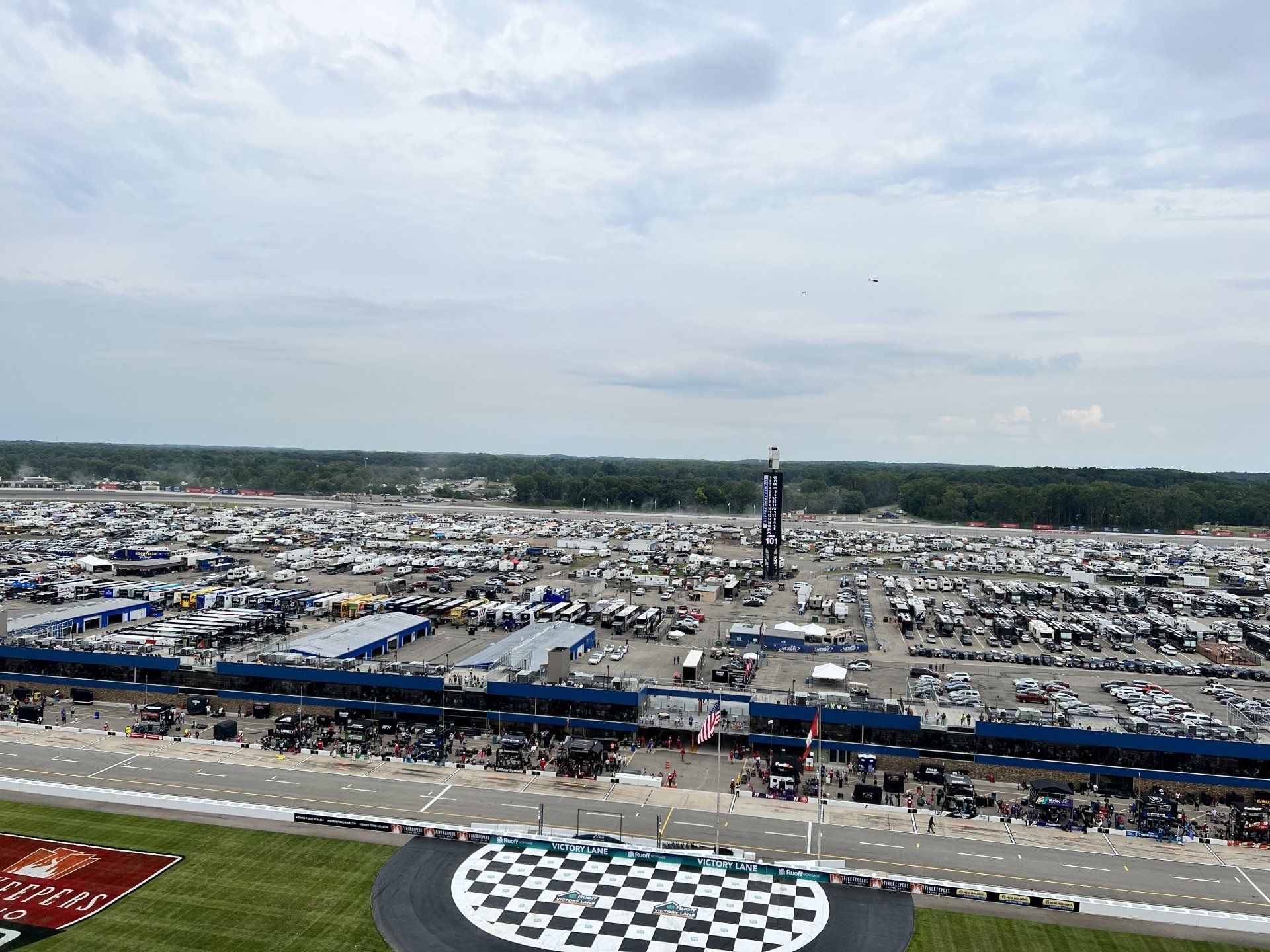 An aerial view of a race track with a checkered flag in the middle