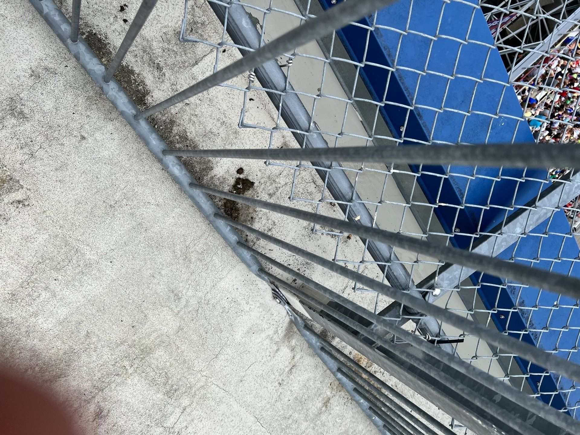 A chain link fence is surrounding a concrete staircase