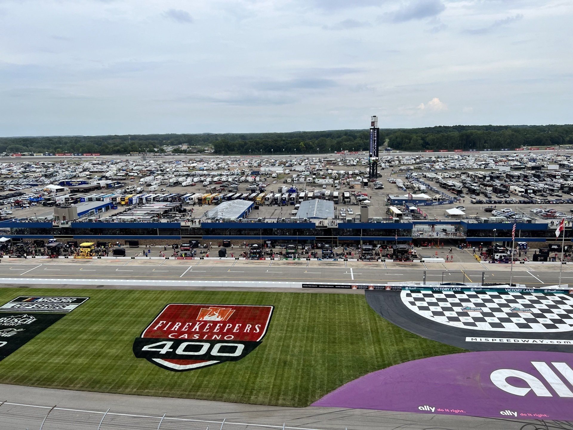 An aerial view of a race track with a 400 logo on the grass