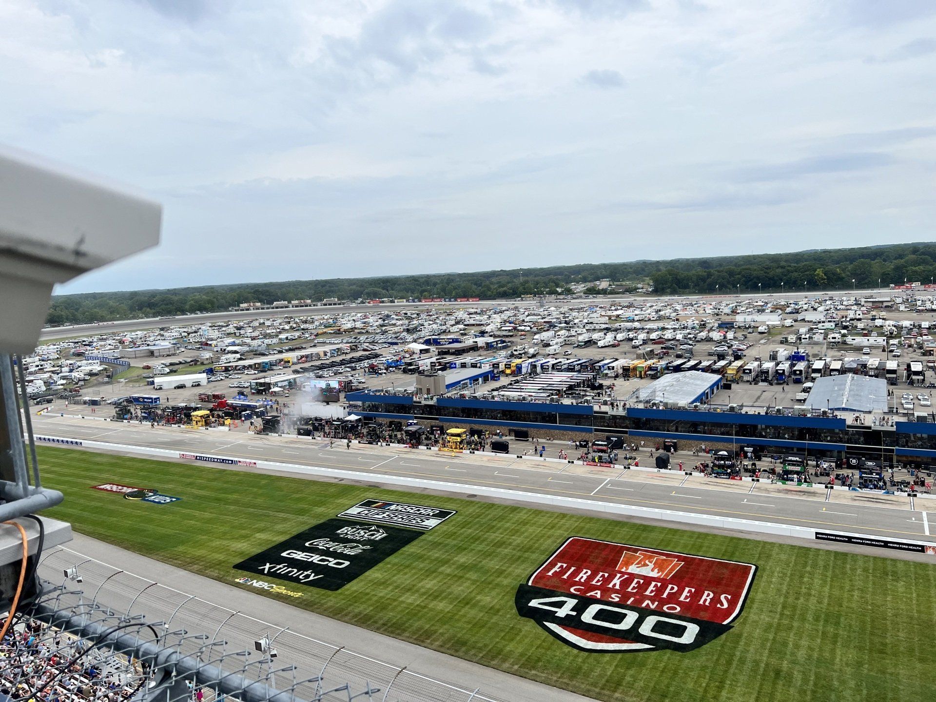 An aerial view of a race track with a large 400 logo on the grass.