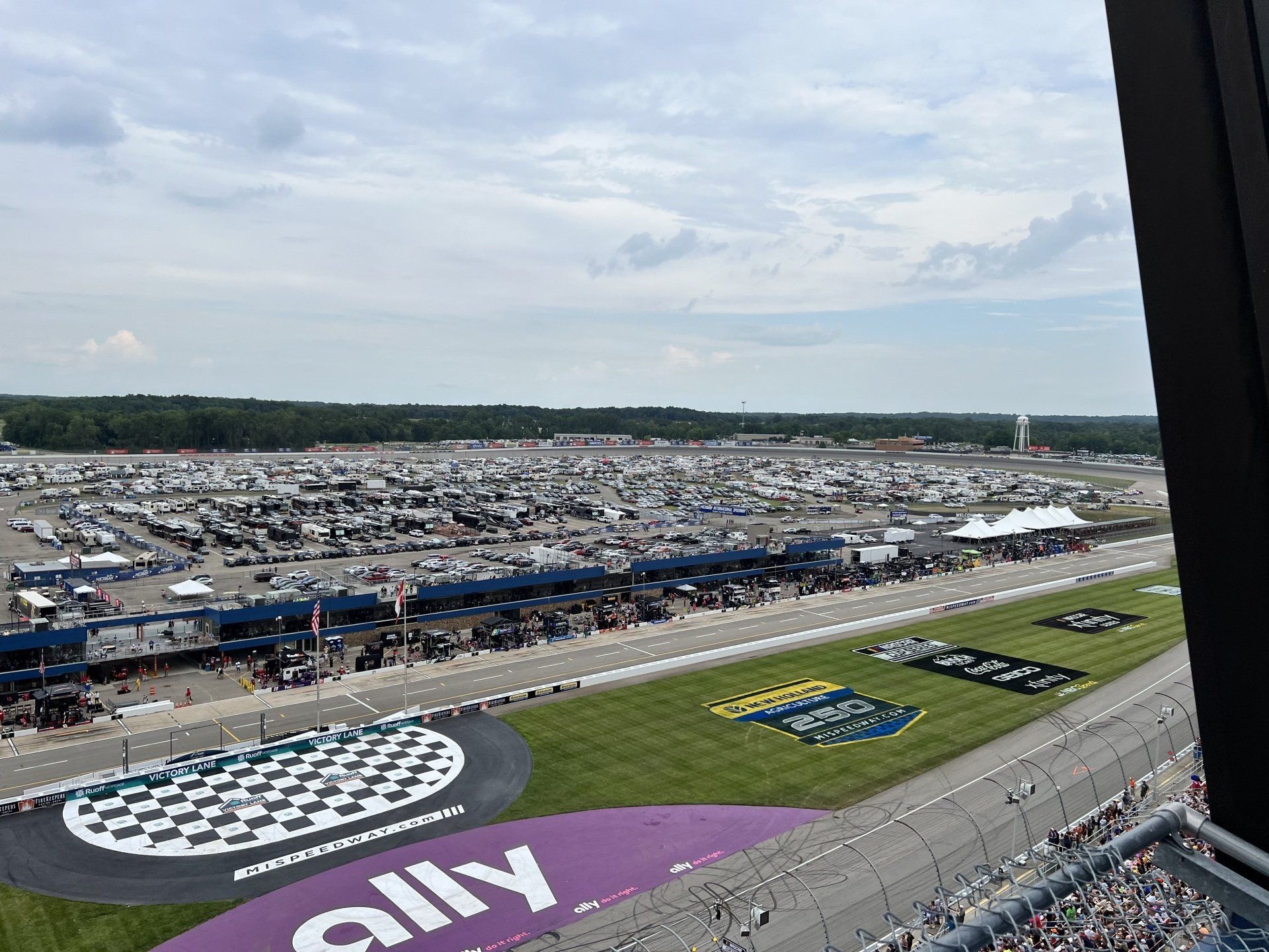 An aerial view of a race track with a purple sign that says rally