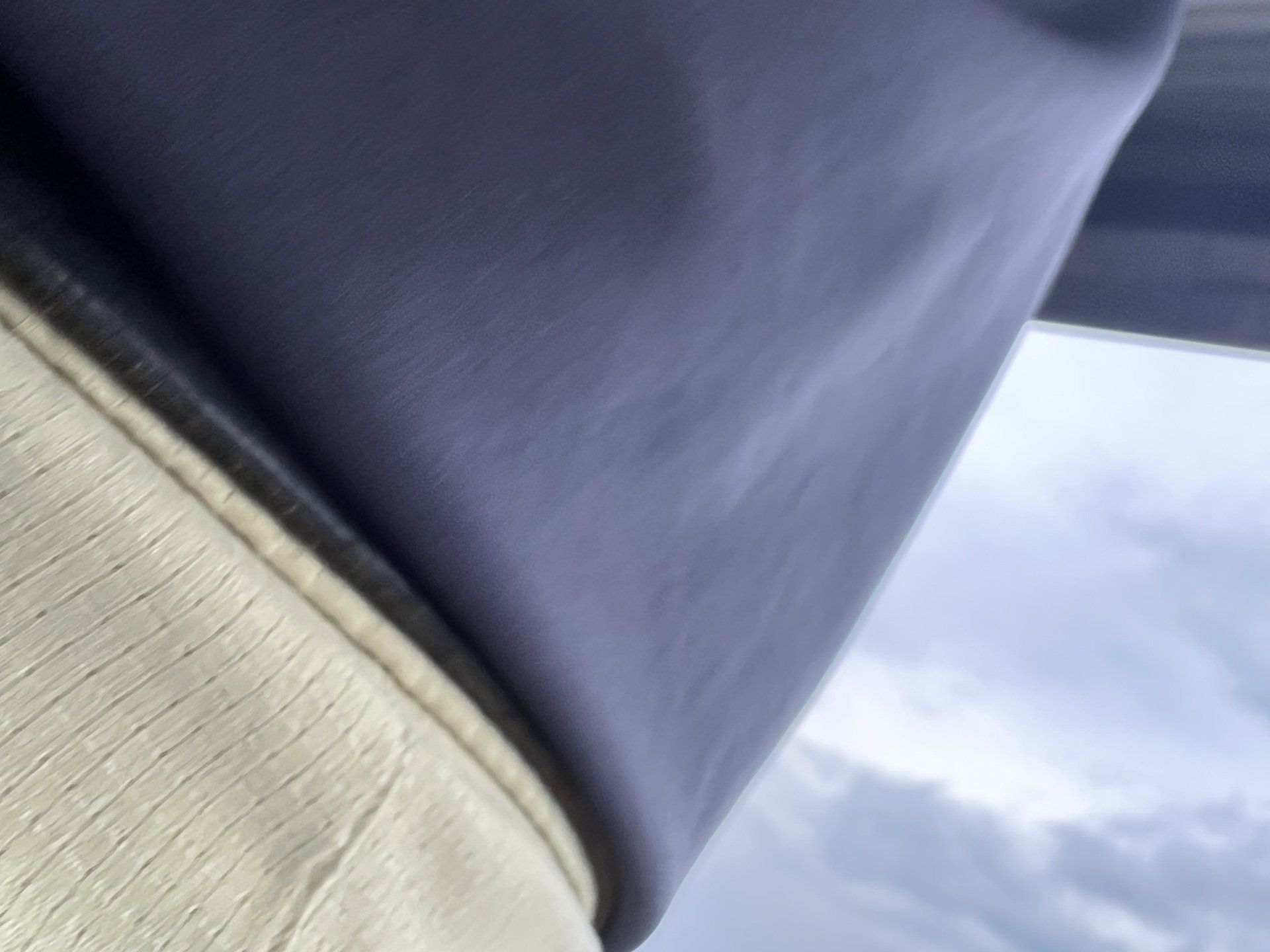 A close up of a piece of fabric with a cloudy sky in the background
