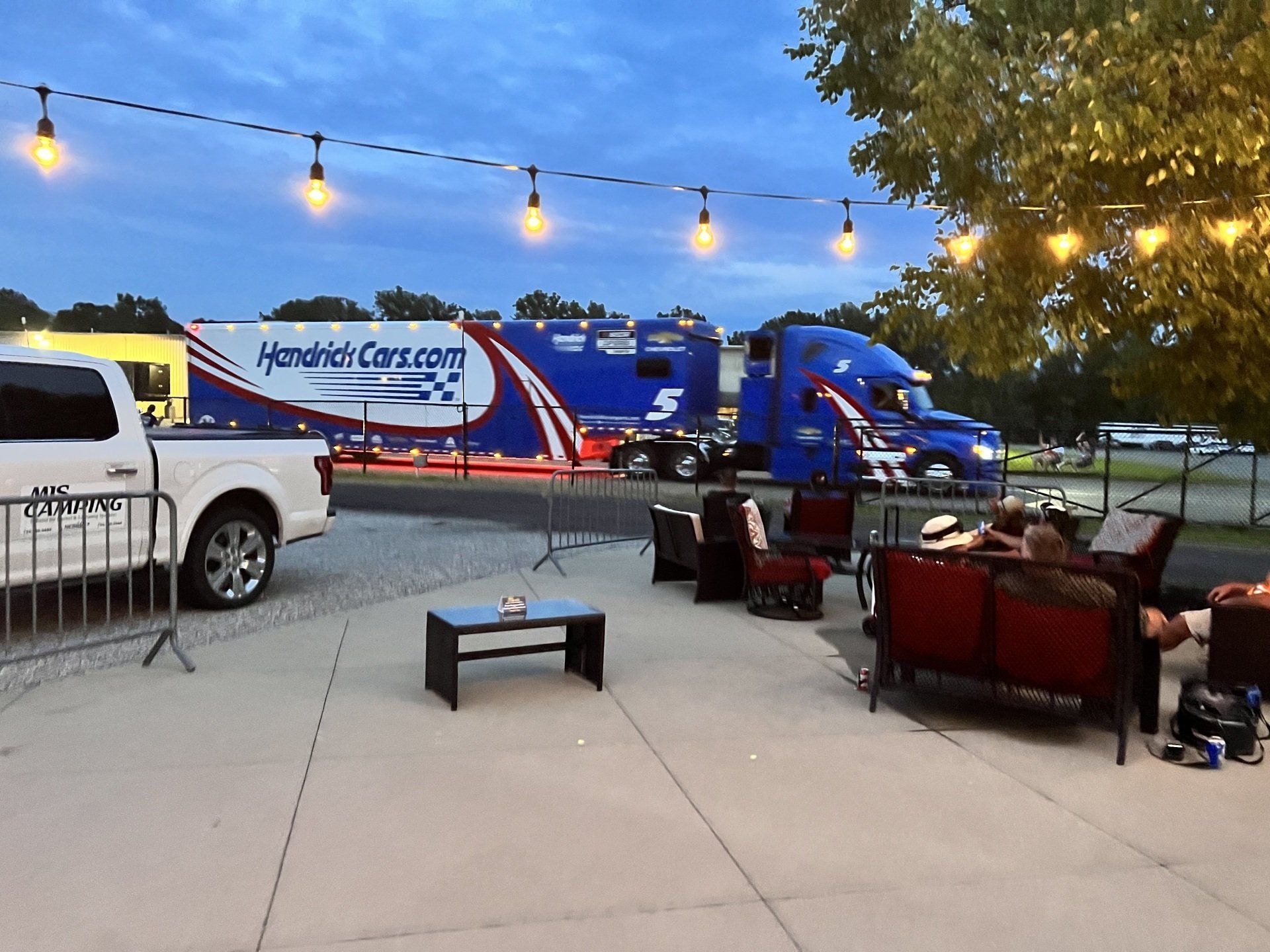 A truck that says ' hendrick cars.com ' on the side of it