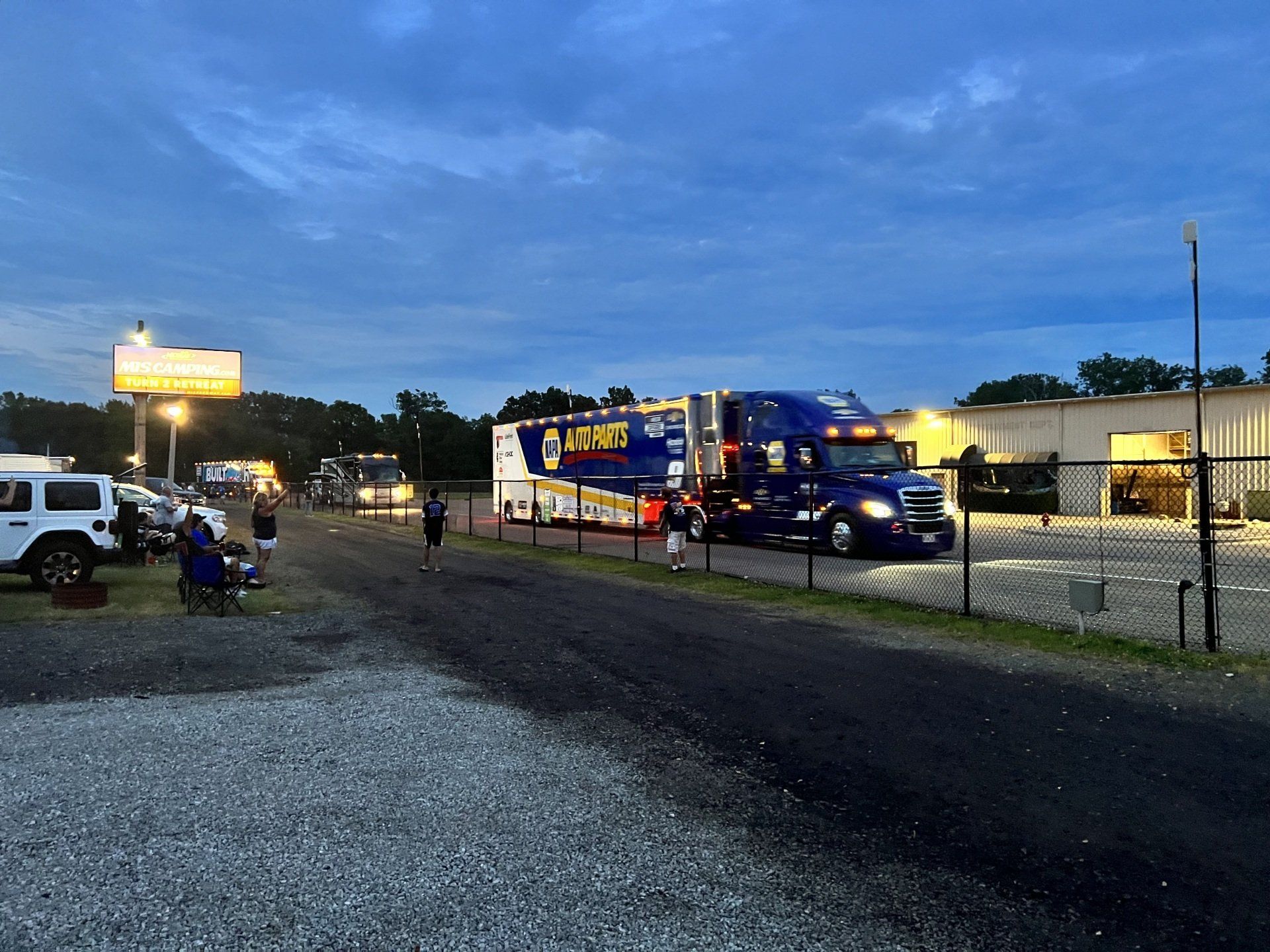 A large blue lorry is parked on the side of the road