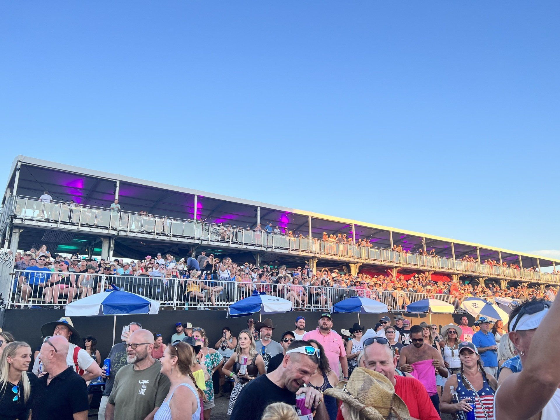 A crowd of people are standing in front of a large building.