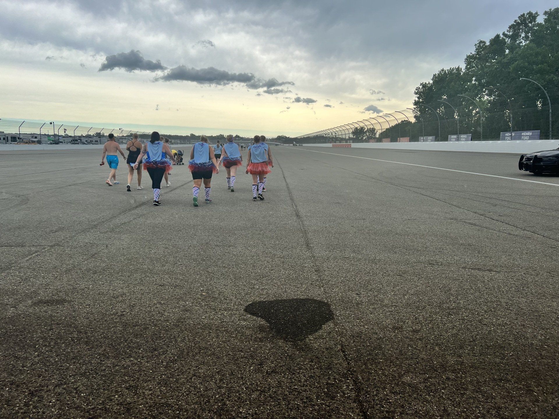 A group of people are walking down a road