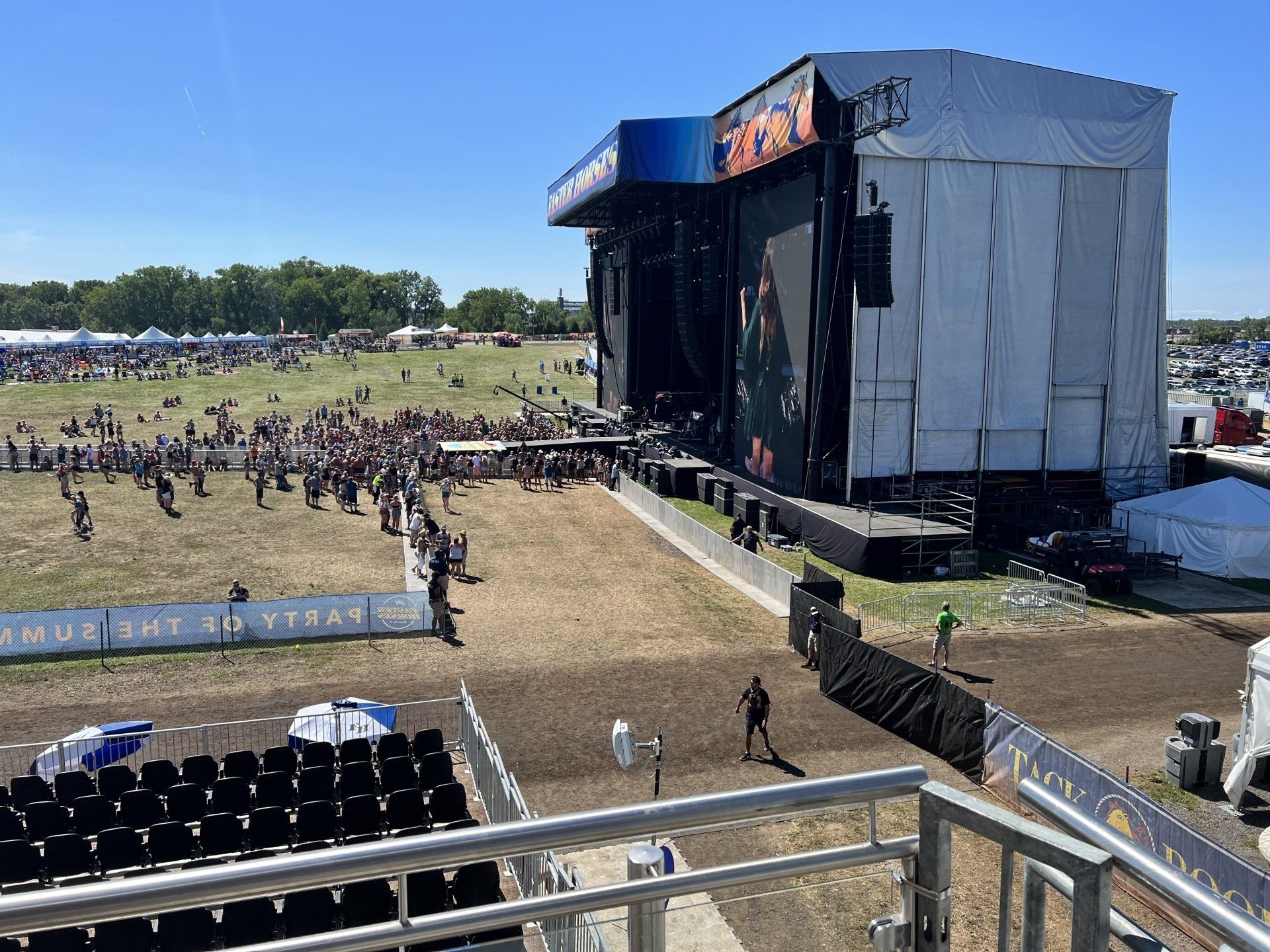 A view of a large stage at a music festival from a balcony.
