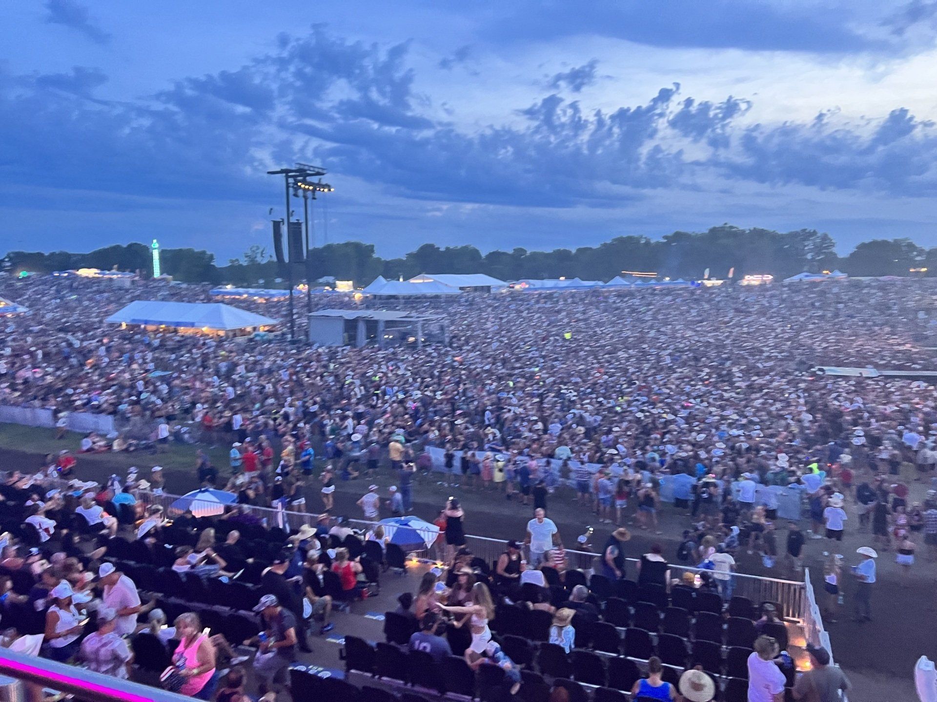 A large crowd of people are gathered at a concert.