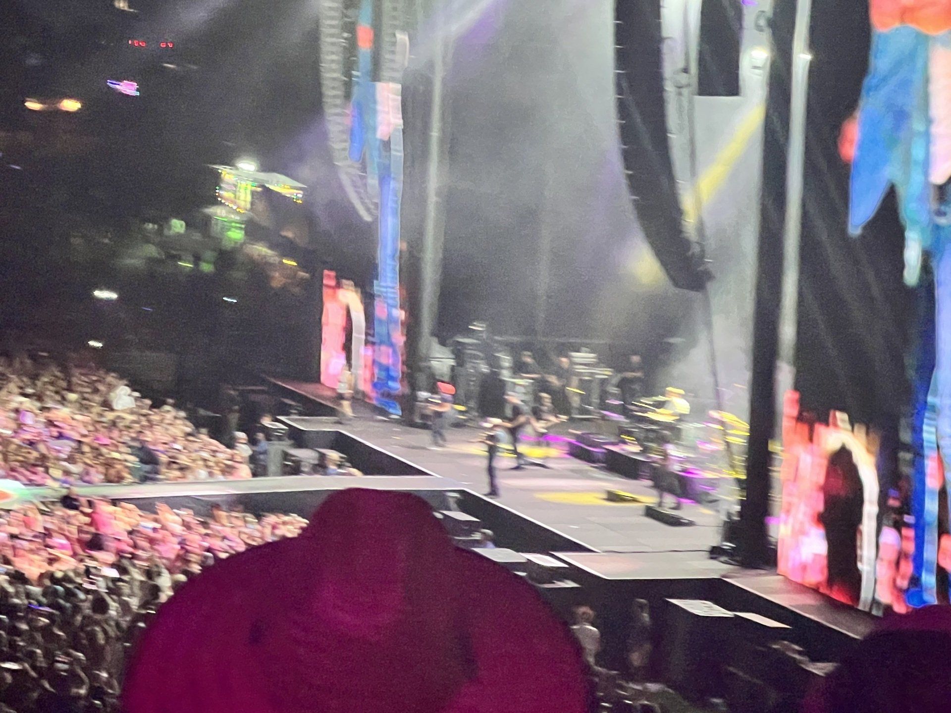 A crowd of people are watching a band on stage