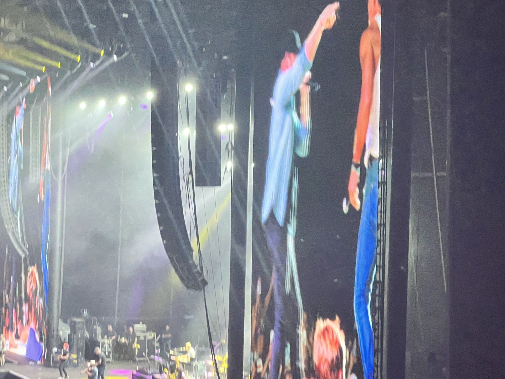 A man is standing on a stage with a microphone in his hand.