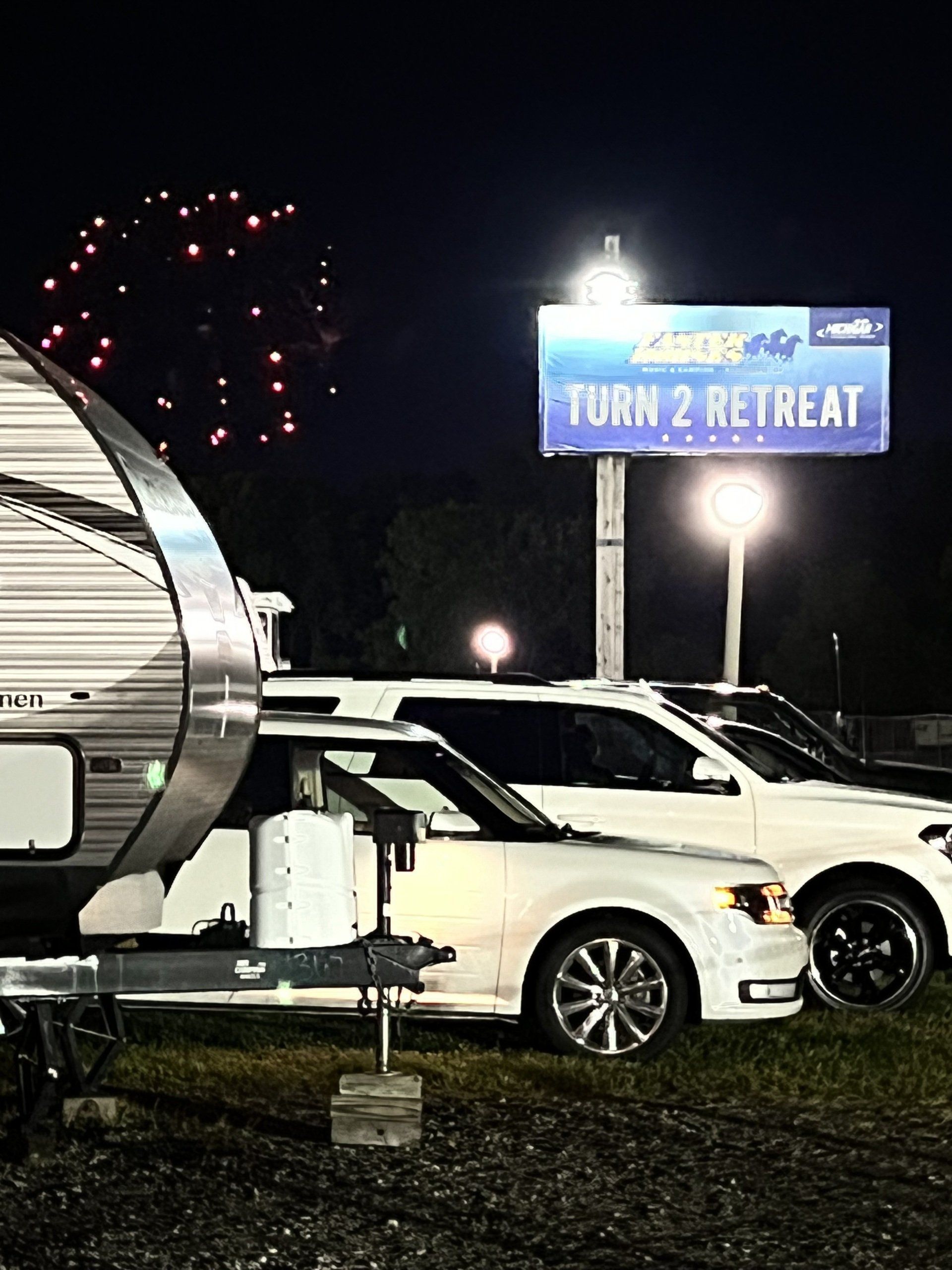 A trailer is parked in front of a sign that says turn 2 retreat