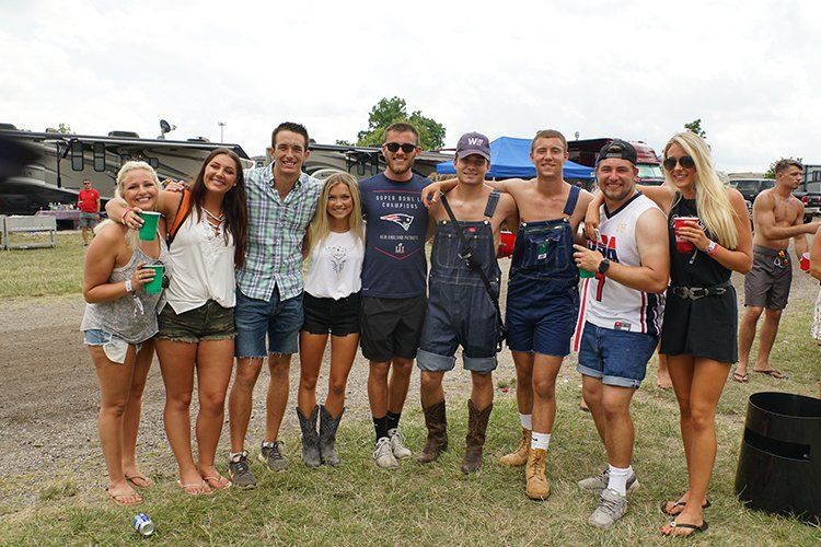 A group of people are posing for a picture in a field.
