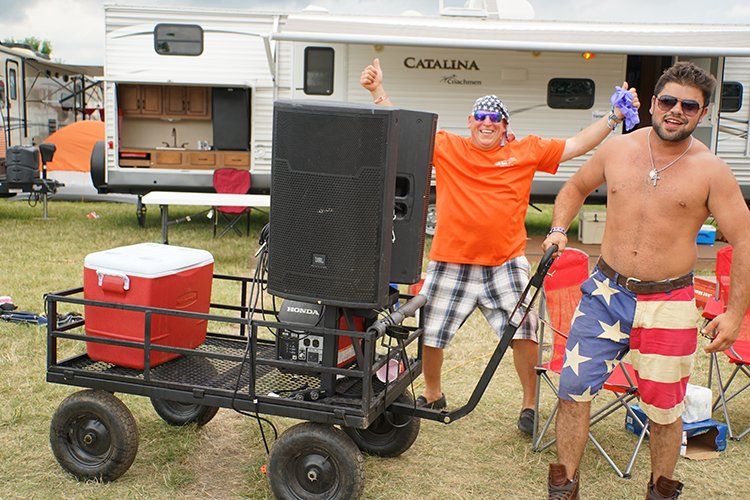 Two men are standing in front of a trailer that says catalina