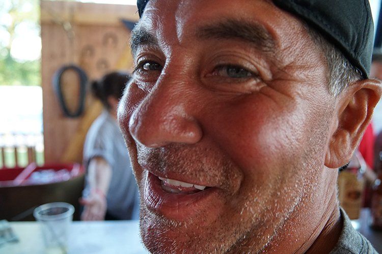 A close up of a man 's face with a hat on