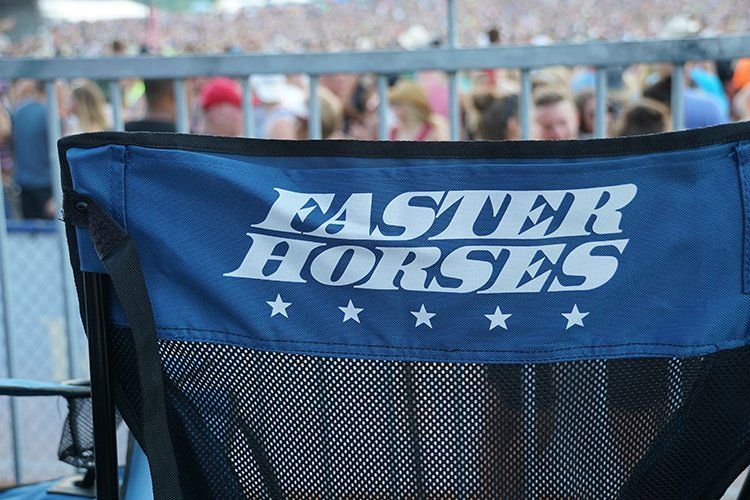 A blue chair with the words faster horses on it