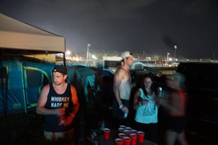 A man wearing a tank top that says whiskey made me