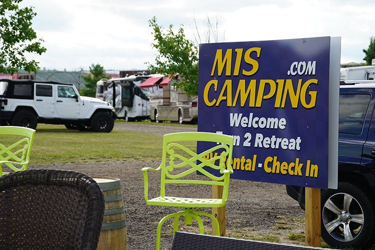 A purple sign that says mis camping on it
