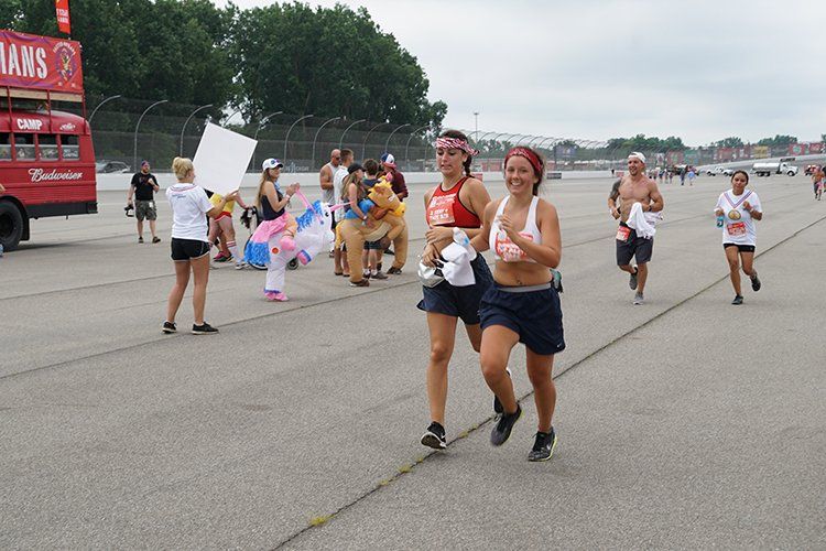 A group of people running in front of a truck that says banks