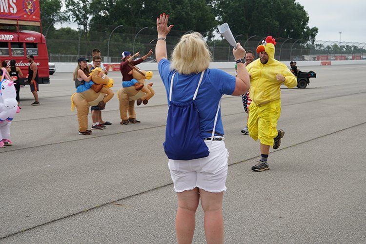 A woman is taking a picture of a group of people in costumes