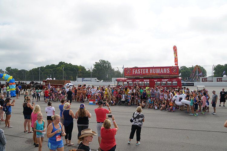 A large group of people are gathered in front of a fast food stand.