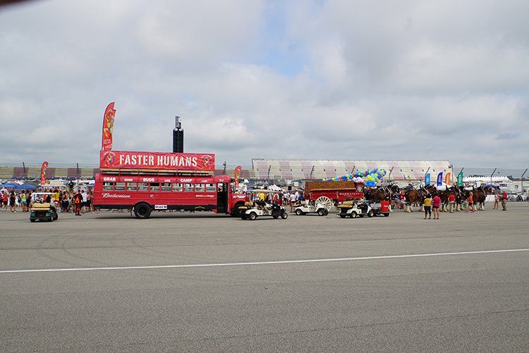 A red fast food truck is parked in a parking lot