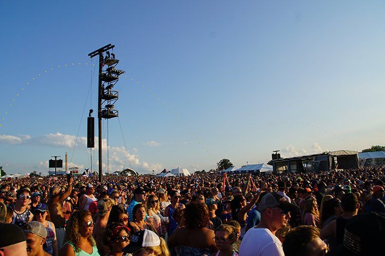 A large crowd of people are gathered at a concert