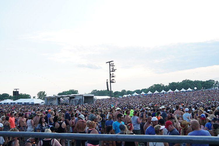 A large crowd of people are gathered at a concert.