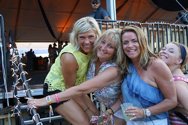 A group of women are posing for a picture together.