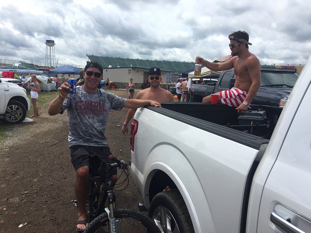 A man is riding a bike in the back of a truck.