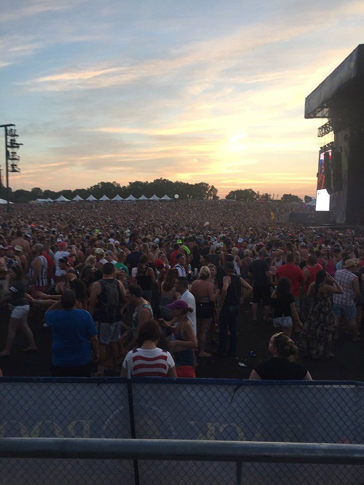 A large crowd of people are gathered at a concert