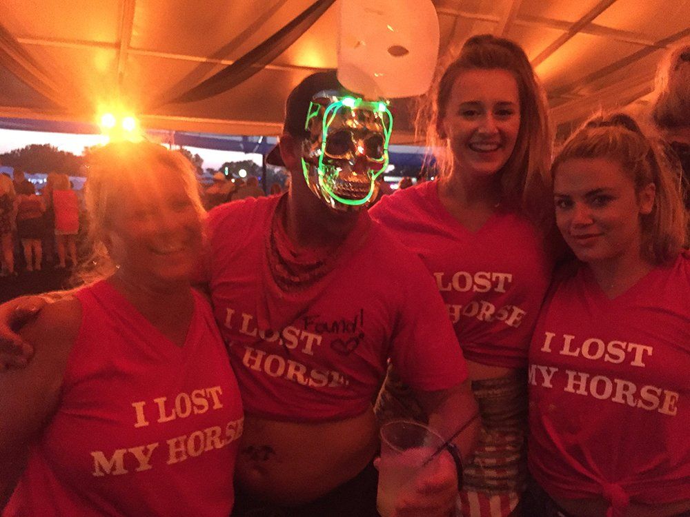 A group of people wearing pink shirts that say i lost my horse