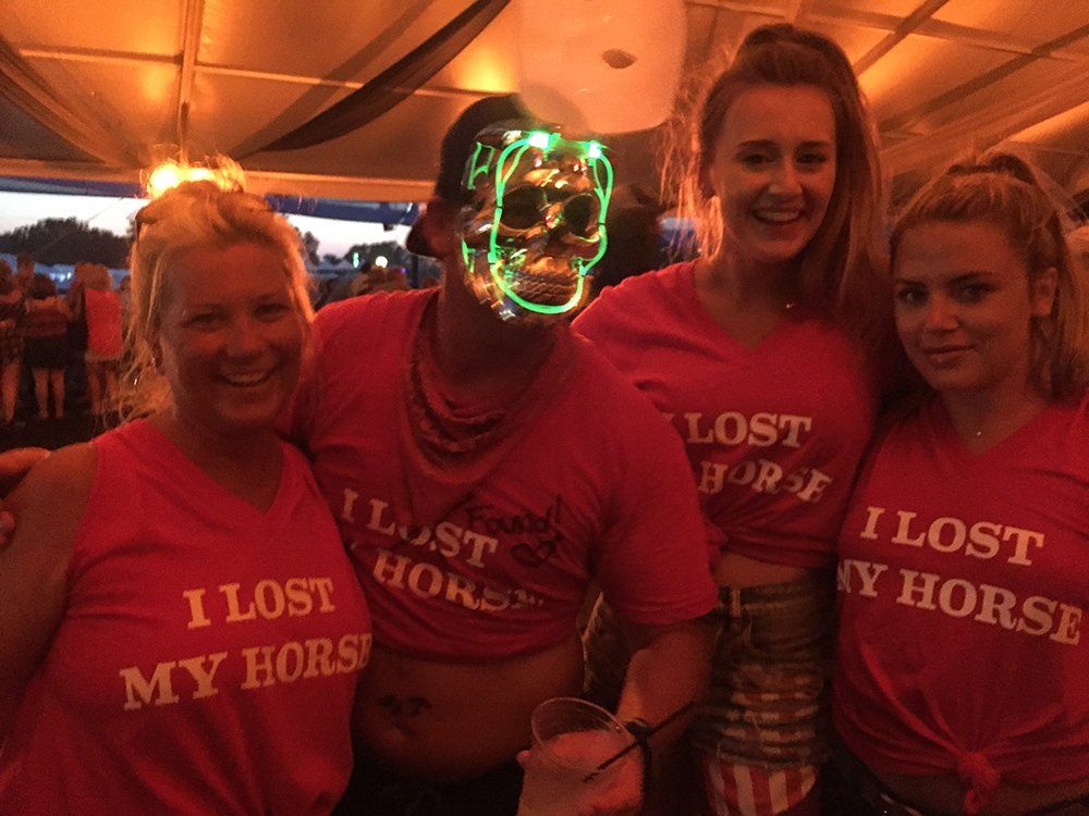 A group of people wearing i lost my horse shirts are posing for a picture.