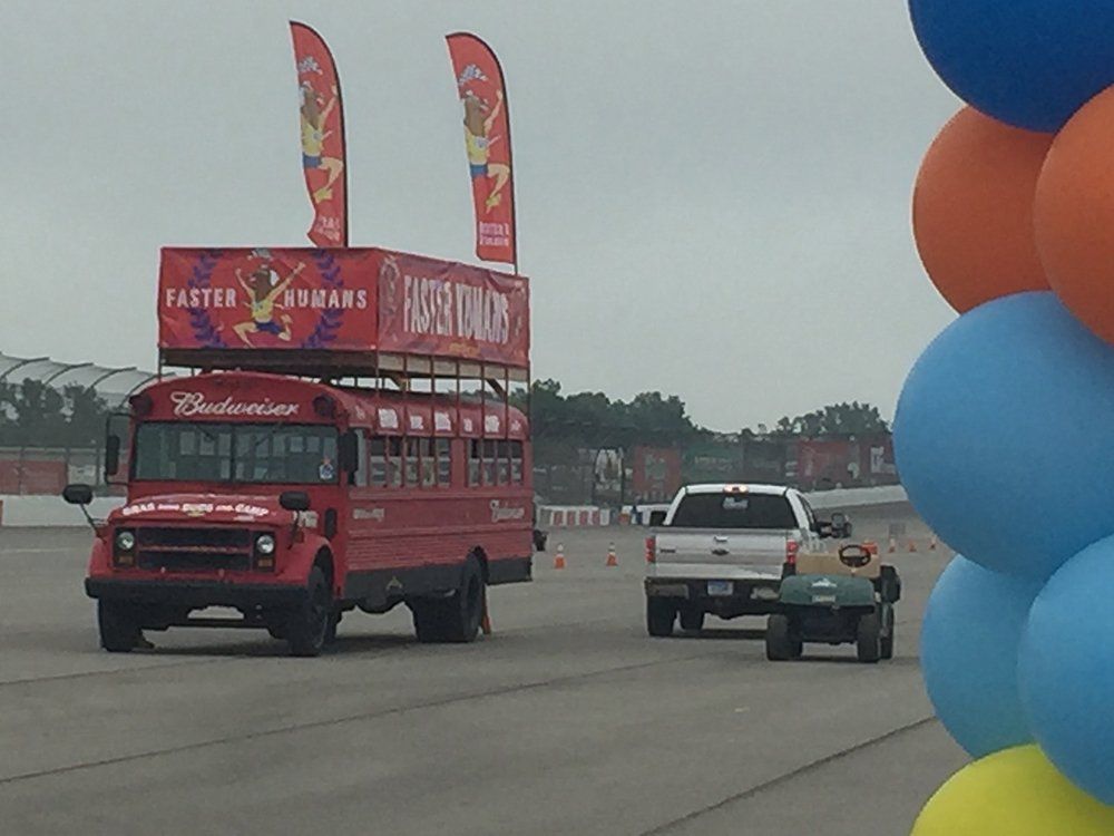A red bus with the word budweiser on it
