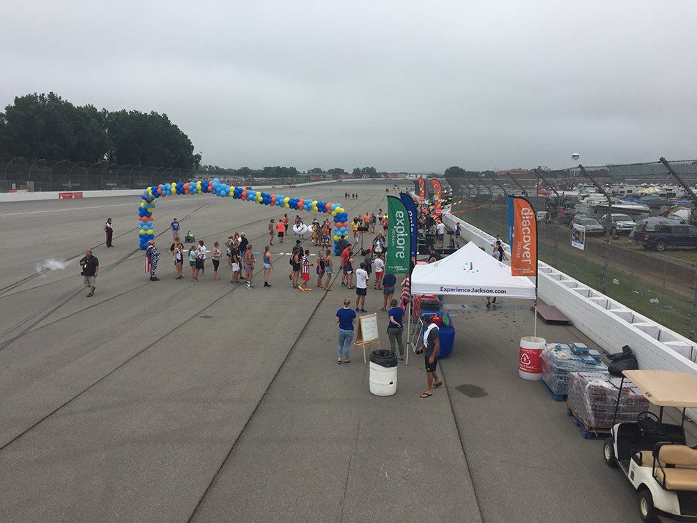 A large group of people are gathered on a race track